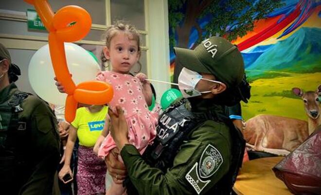 Policía interactúa con una niña durante jornada de acompañamiento hospitalario.
