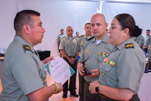 Entrega de diploma a un policía que trabaja por la paz