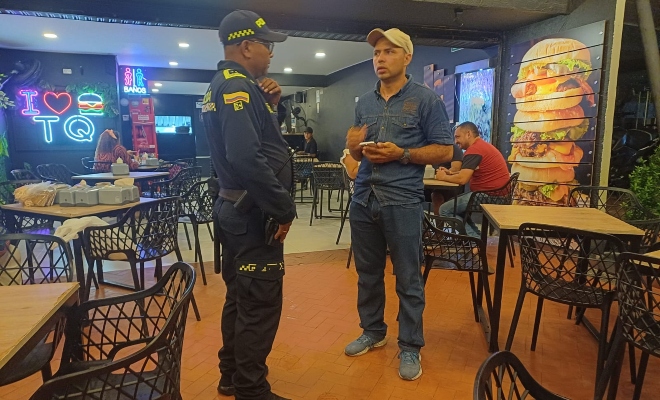 Funcionario policial brindando recomendaciones a un ciudadano en establecimiento público 
